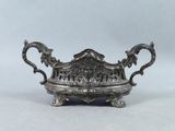 an antique silver plate with ornate design on it