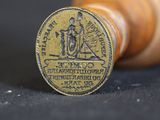 a close up of a wooden stamp on a black surface