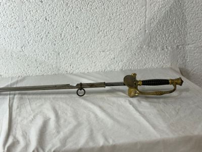 an old sword sitting on top of a white sheet next to a wall