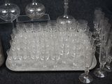 a lot of glasses and a tray on the table