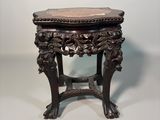 an antique wooden table with a marble top on a white background
