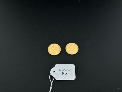 a pair of gold coins with a price tag on a black background