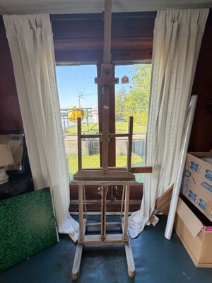a wooden rocking chair in the corner of a room