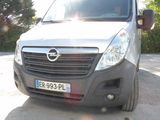 a silver van that is parked on the side of the road