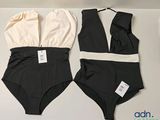 two swimsuits sitting on a table next to each other