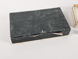 a small box that has a book inside of it
