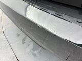 a close up of a car ' s bumper with scratches on it