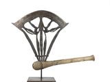sculpture of a baseball bat and a shield on a stand