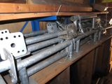a bunch of metal pipes on a shelf in a room