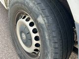 a tire on the side of a truck with holes in it
