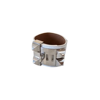 silver metal cuff bracelet with spikes and spikes on the sides
