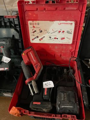 a red tool box with tools in it on the floor