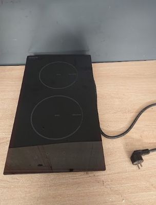 a black stove top with two burners and a power cord