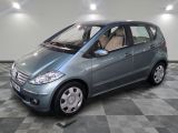 a picture of a small blue car parked in a garage