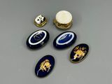 four pieces of blue and gold brooches and a gold ring