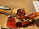 a pipe and a pipe holder sitting on a table