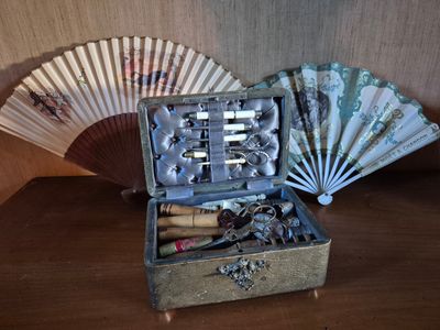 a wooden box with a bunch of keys and a fan