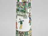a vase with a painting on it sitting on a table