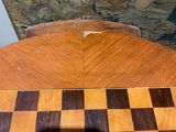 a wooden table with a chess board on top of it