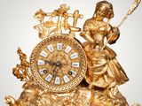 a gold clock that is sitting on a table