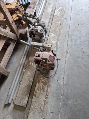 a machine that is sitting on the floor next to a pile of wood