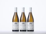 three bottles of wine sitting on top of a white table