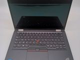 the laptop is open on a white surface with a black keyboard