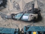 a drill on the ground next to some other tools