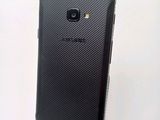 the back of a black samsung galaxy s4 phone with a white background