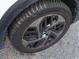 a close up of a tire on a white car