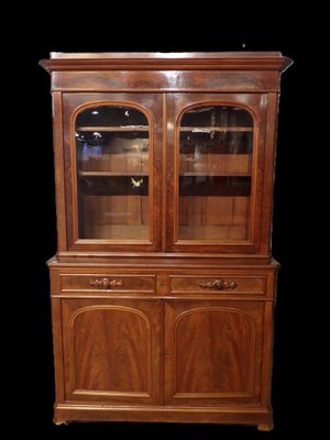 a wooden china cabinet with glass doors and drawers