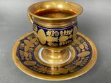 a cup and saucer sitting on a saucer on a table