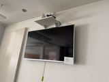 a flat screen tv mounted on the wall in the corner of a room
