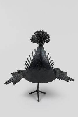 an image of a black bird statue on a white background