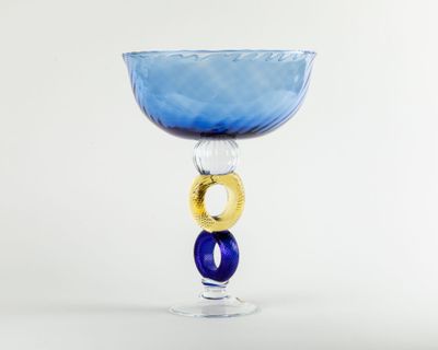 a blue glass with a gold ring on it