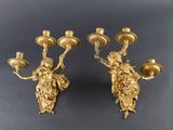 pair of antique brass candlesticks with cherenshes on them