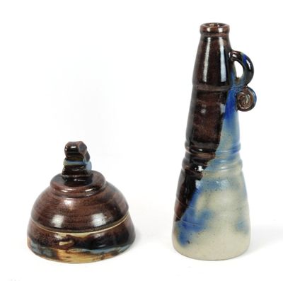two vases sitting next to each other on a white surface