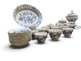 a lot of plates and bowls that are sitting on a table