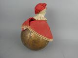 a figurine of a woman sitting on top of a ball