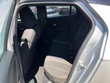 the back seat of a car with the door open in a parking lot