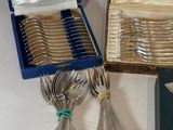 a lot of silverware in a box on a table