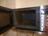 a microwave with a pan inside of it on a counter