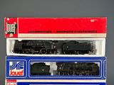 two black and red model trains sitting on top of each other