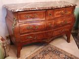 a marble top chest of drawers in a living room