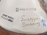 a statue of a woman with a bird on her head