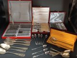 a lot of silverware in a red case on a table