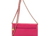 a close up of a pink purse on a white background