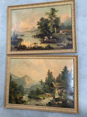 Deux tableaux représentant un paysage de montagne sont accrochés au mur.