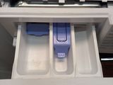 a drawer that has two plastic containers inside of it