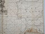 an old map of the world is shown on a table